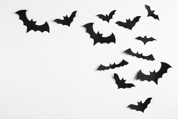 Halloween paper bats on grey background