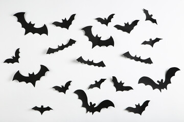 Halloween paper bats on grey background