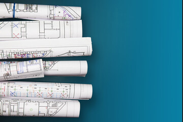 Architectural project, drawings on a dark background. Rolls of project drawings