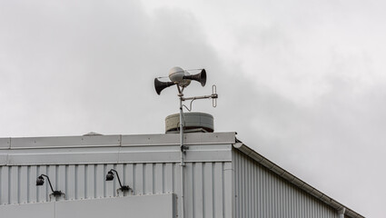 Civil protection alarm siren on the roof of a building.