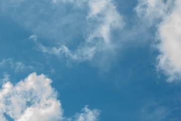 cumulus and high-cumulus clouds of an average tier on blue heavenly space
