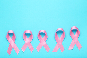 Cancer concept. Pink ribbons on blue background