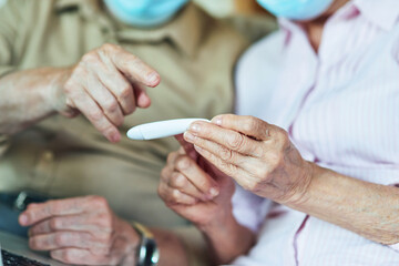 Close up of two pensioners looking at the thermometer