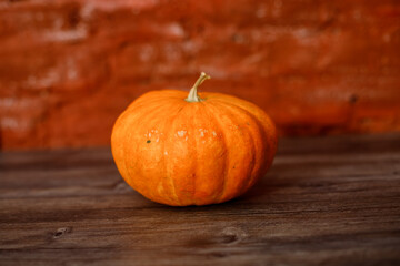 Pumpkin on the table or pumpkin on a wooden background