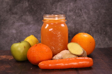 Delicious healthy Smoothie with orange, lemon, apple, carrots, mandarin, and ginger