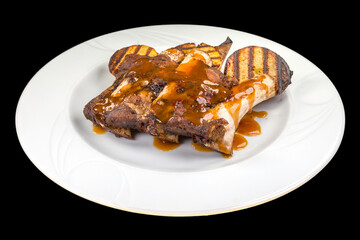 Delicious Veal ribs with grilled potatoes on a white plate,