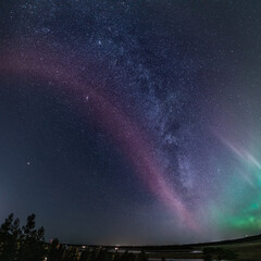 Very rare amazing photo of whole Milky Way panorama with celestial STEVE Phenomenon, green Aurora lights below, Northern Sweden landscape. 23 October 2020, Umea city, Sweden