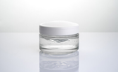 Transparent jar of cream on a white background without a label. Side view. The concept of cosmetology.