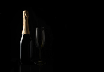 Champagne on a black background with space to copy. Side view. Concept of alcoholic beverages.