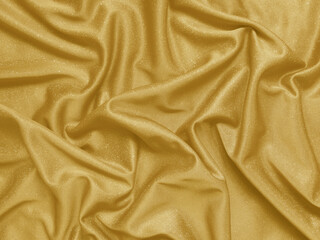 Shiny gold crumpled fabric. Elegant cloth texture background