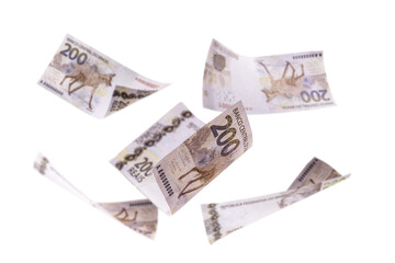 many 200 reais banknotes falling, two hundred banknotes isolated white background, brazilian money falling, with punctual focus