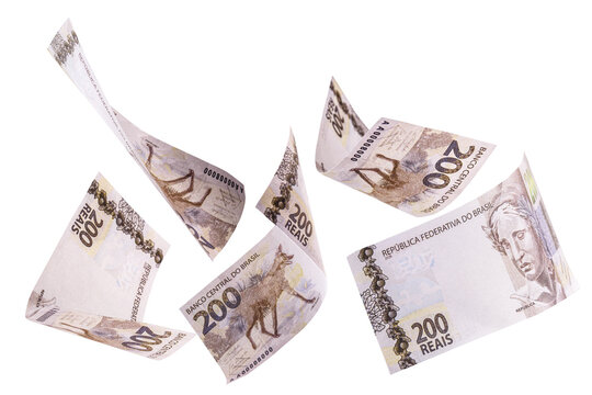 200 reais banknotes, bank notes falling on isolated white background. Two hundred reais from brazil, selective focus. Fall, inflation and loss concept