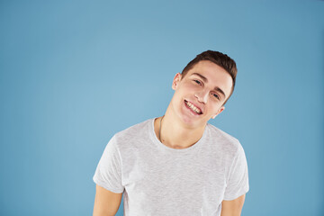 Emotional man in white t-shirt cropped view on blue background lifestyle