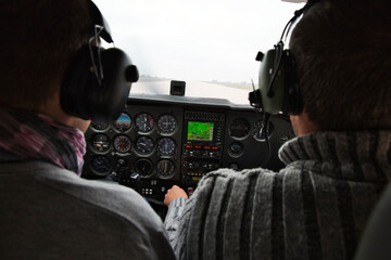 view from over snow covered peaks while flying in small plane