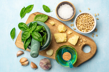 Fototapeta na wymiar Ingredients for cooking italian pesto sauce on concrete background