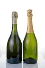 Two bottles of champagne without labels on a light background. Side view. Concept of alcoholic beverages.