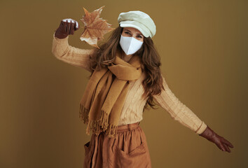 smiling stylish woman in sweater against bronze background