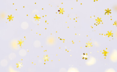 Festive Christmas and New Year background with golden decorations and bokeh light on white background. 