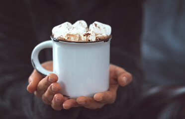 Close-up of a white mug with hot chocolate and marshmallow