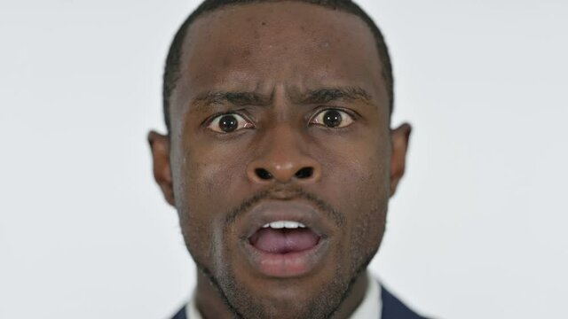Close up of Shocked Young African Man, White Background 