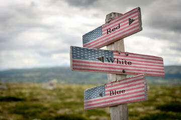 red white blue text on signpost with the american flag painted on