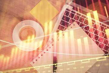 Double exposure of forex chart drawing over table background with computer. Concept of financial research and analysis. Top view.