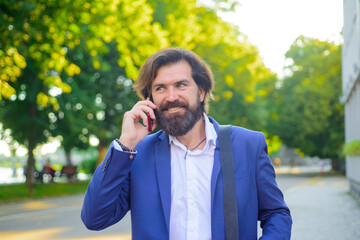 Businessman talking on phone outdoor. Bearded businessman outdoor. Business.