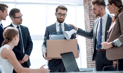 business colleagues say goodbye to the dismissed employee