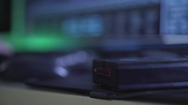 Male hand inserting card in USB card reader. Unrecognizable computer programmer coding in darkness. Unknown Caucasian hacker doing cyber attack with online virus.