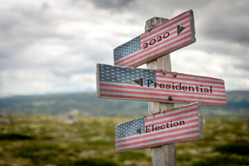 2020 presidential election text on wooden signpost with the american flag on