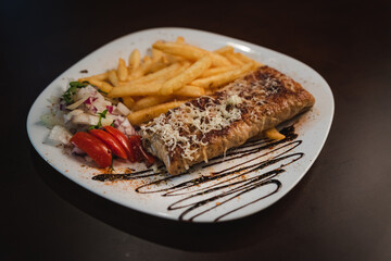roast meat with cheese and salad on a plate and salad on a plate