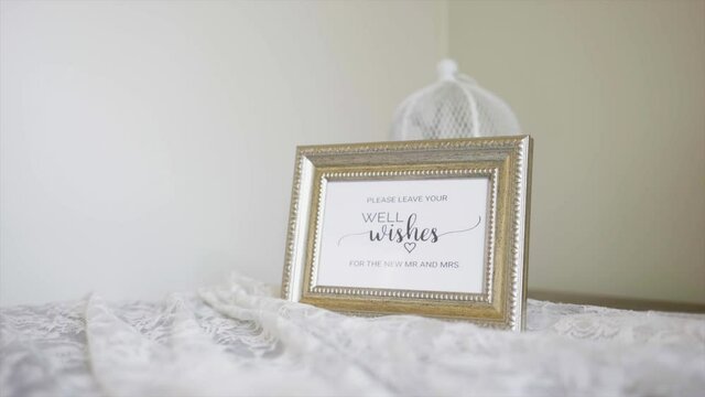 please leave your well wishes for the new mr and mrs frame billboard on the white table
