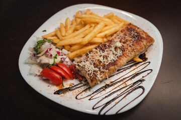 roast meat with cheese and salad on a plate and salad on a plate