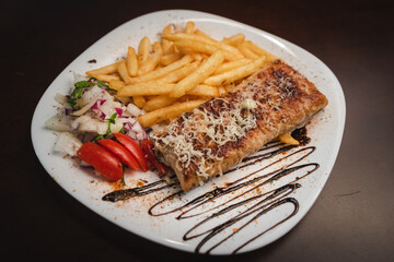 roast meat with cheese and salad on a plate and salad on a plate