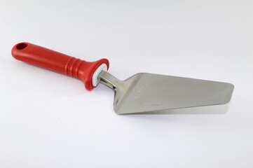 Spatula used to serve pizza with red handle