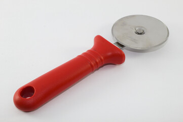 Circular pizza cutter with red handle and white background