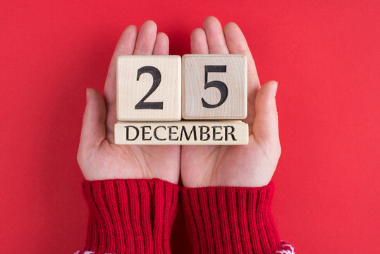 Top Above Overhead Close Up First Person View Photo Of Female Teenager Hands Holding Wooden Calendar With Christmas Date Isolated Over Red Background