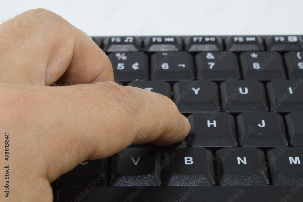 Poster hand typing on the keys of a computer keyboard