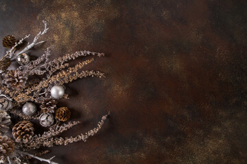 Christmas background, the composition of their cones and dried flowers on a dark brown background. Abstract composition, idea, decor.
