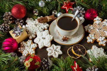 Cup of coffee with gingerbread and fir branches with cones, Christmas balls. New Year's holiday concept.