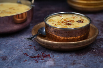 Obraz na płótnie Canvas Indian rice pudding kheer pal payasam in traditional serving dish