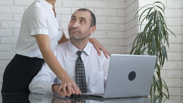 Office harassment. The woman sexually explains to the employee.