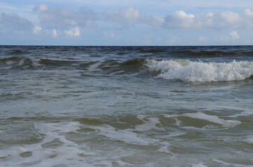 A wave from the ocean goes to the shore