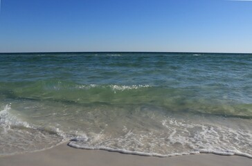 A wave from the ocean goes to the shore