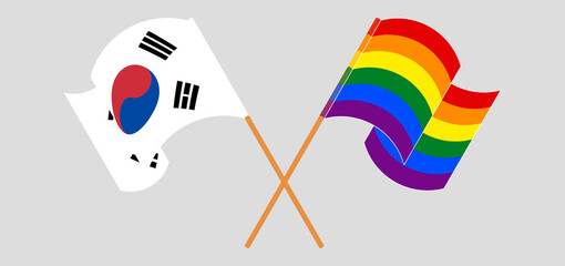 Crossed and waving flags of LGBTQ and South Korea