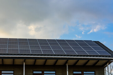 Naklejka premium Solar panels on roof of residential house. Clean energy. Ecological concept