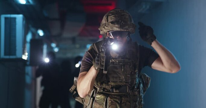 Male commander with gun giving orders to SWAT team