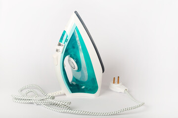 modern new electric iron on white background, ironing, clothes, housework and objects concept