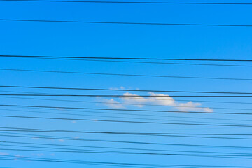 High voltage power line wires against the sky