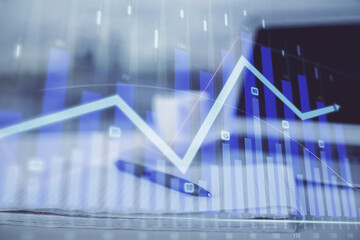 Double exposure of financial graph drawings and desk with open notebook background. Concept of forex market